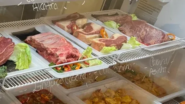 Bone-in steaks and beef ribs in the butcher case at Costa's Meat Market