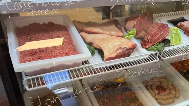 Freshly ground beef (carne moída de primeira) and whole beef cuts at Costa's Meat Market